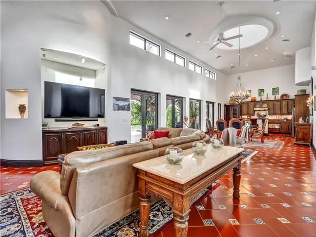 Living area featuring high ceilings, a circular ceiling detail with a fan, and clerestory windows