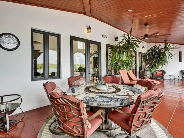 Expansive outdoor living area featuring a terracotta tile floor and a wood-paneled ceiling