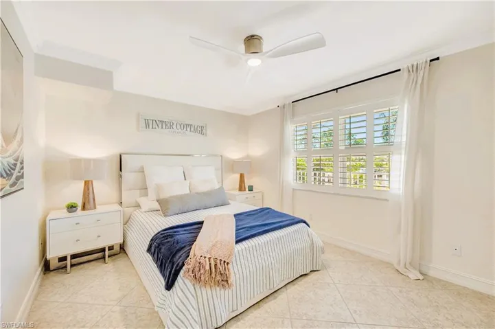 Second guest bedroom with ornamental molding and ceiling fan