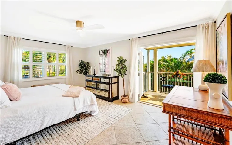 Primary bedroom with crown molding, ceiling fan, access to lanai