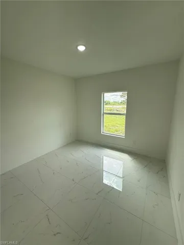 Spare room with light marble finish flooring and recessed lighting