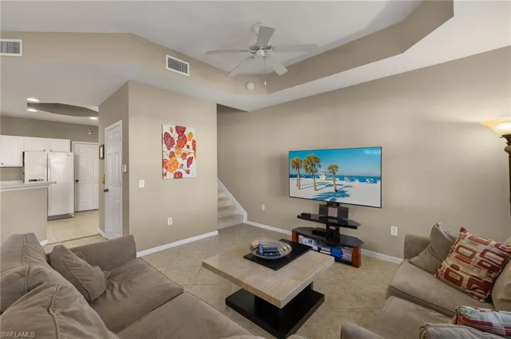 Tiled living room featuring ceiling fan