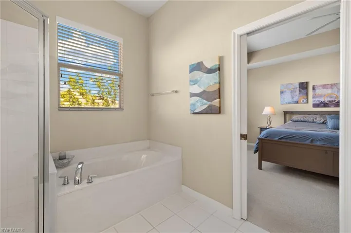 Bathroom with separate shower and tub and tile patterned floors