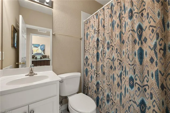 Bathroom with vanity, toilet, and walk in shower