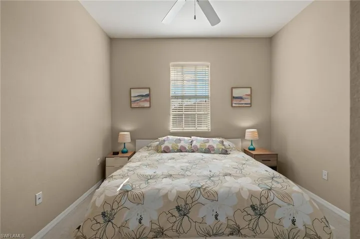 Bedroom featuring ceiling fan and carpet flooring