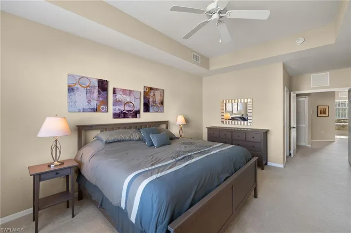 Carpeted bedroom with ceiling fan