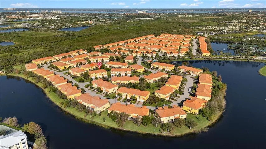 Birds eye view of property with a water view