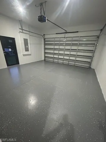 Garage with a garage door opener and electric panel