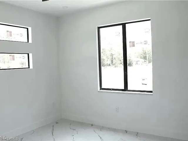 Bright interior space featuring white walls and white baseboards