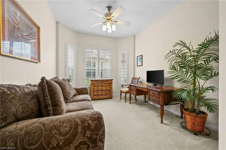 Office space featuring light colored carpet and ceiling fan