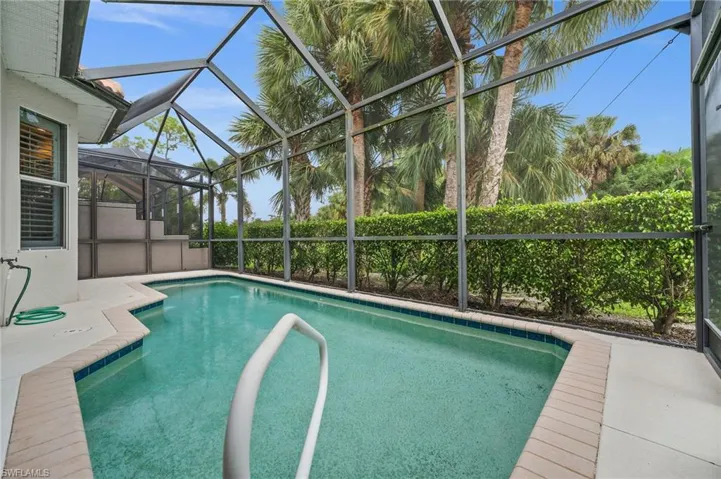 View of pool with a sunroom, a lanai, and a patio
