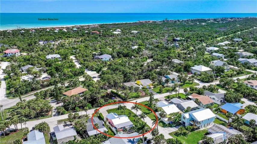 Aerial perspective of suburban area featuring a nearby body of water