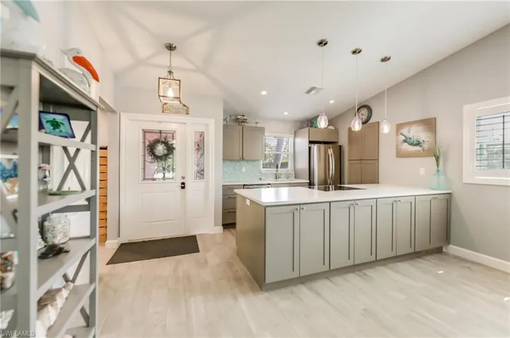 Living room with ceiling fan, lofted ceiling%2