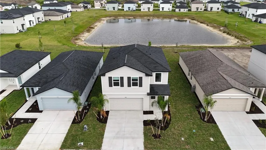 Aerial perspective of suburban area featuring a nearby body of water