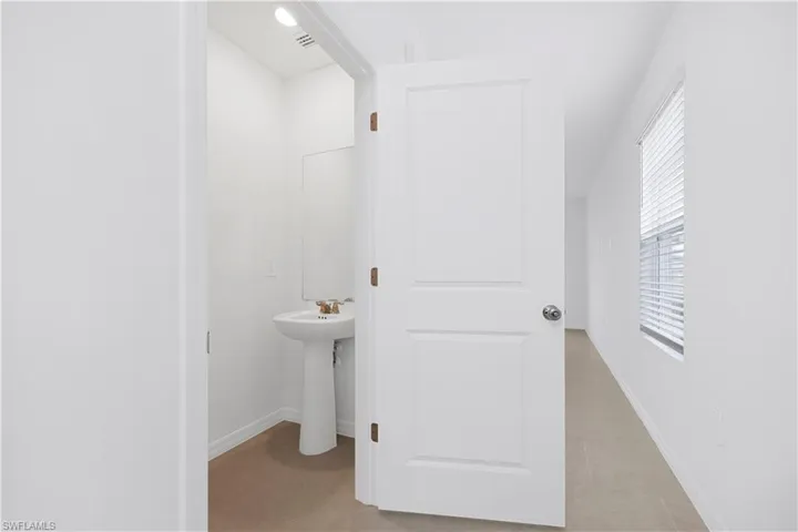 Bathroom with light tile patterned floors and baseboards