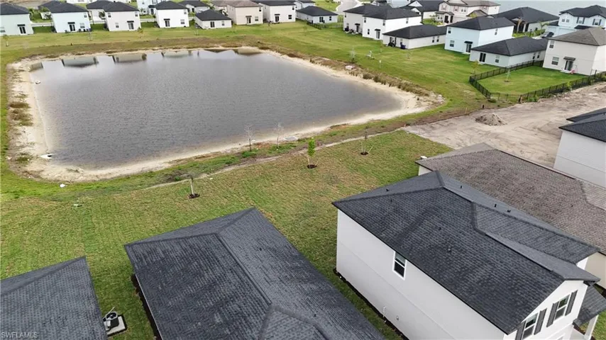 Aerial view of residential area featuring a large body of water