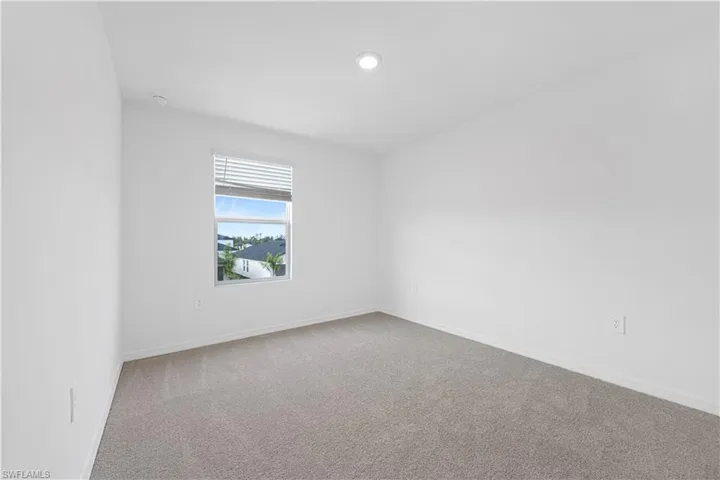 Spare room with carpet and baseboards