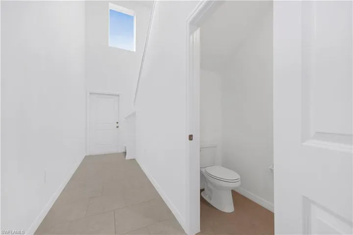 Bathroom with a high ceiling and light tile patterned floors