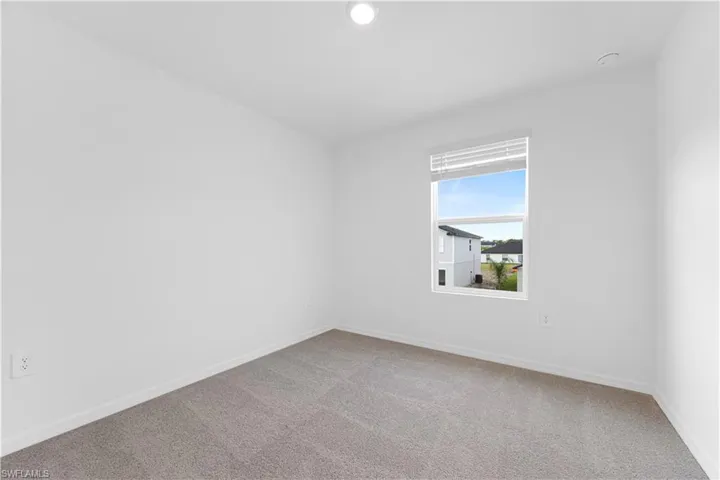 Unfurnished room with carpet floors and baseboards