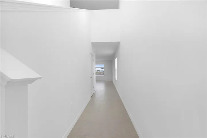 Corridor featuring baseboards