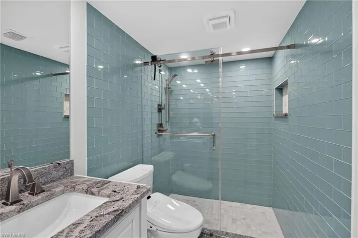 Beautiful sea glass tile work, heavy shower doors