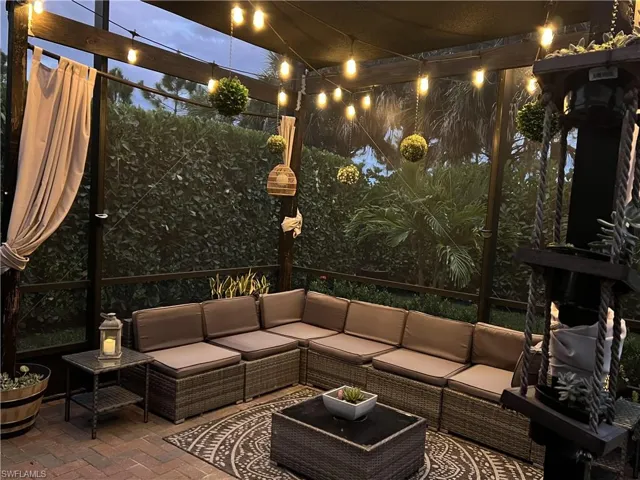 Patio at night featuring an outdoor living space