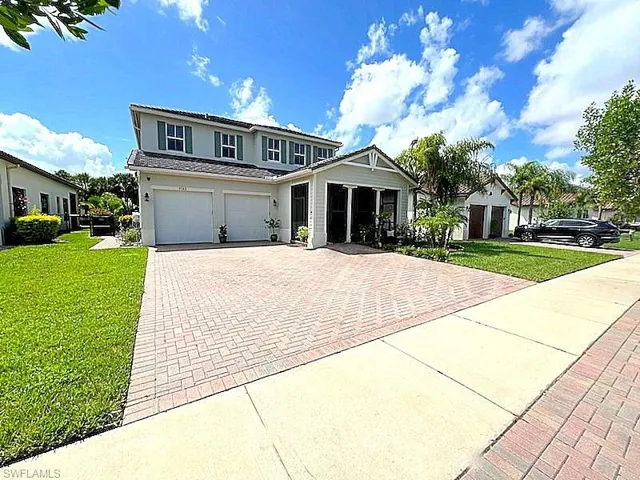 View of front of property featuring a garage and a front yard