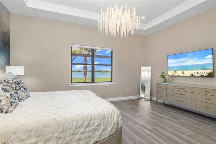 Owner suite with tray ceiling and crown molding.