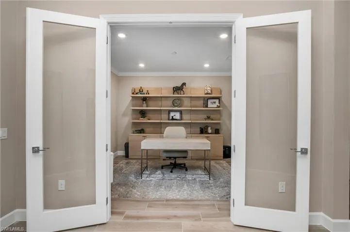 Office featuring ornamental molding and light hardwood / wood-style floors.
