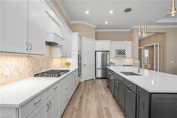 Kitchen with detailed backsplash, contrasting island, and plenty of cabinet space.