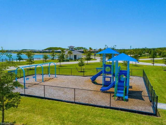 View of jungle gym with a water view and a yard