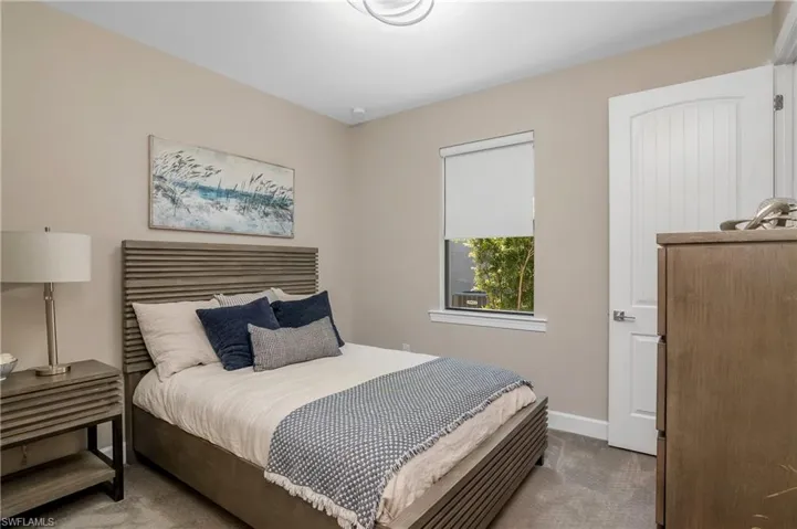 Another guest bedroom has an oversized walk-in closet with custom built-in shelving--perfect for extra storage.