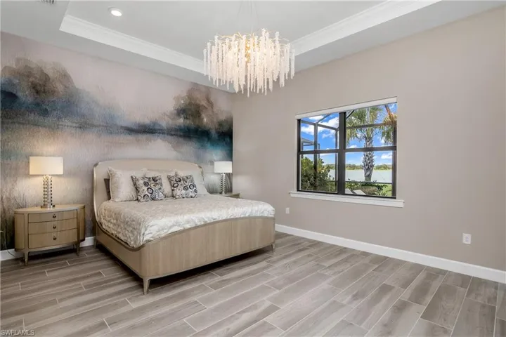 Wake up to fabulous lake views every morning in this HUGE owner suite featuring wood-look plank tile flooring, designer lighting, and custom remote shades.