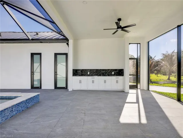 View of patio / terrace with a ceiling fan and glass enclosure