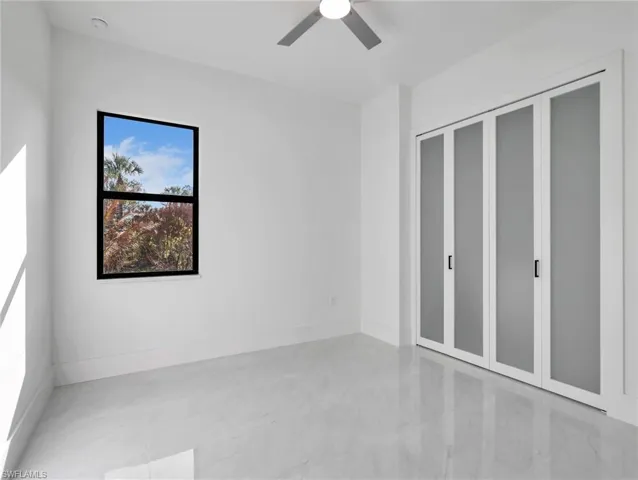 Unfurnished bedroom with a closet and a ceiling fan