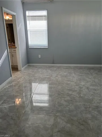 Empty room featuring baseboards