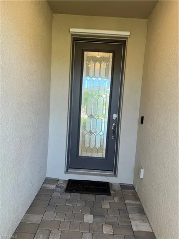 View of exterior entry featuring stucco siding