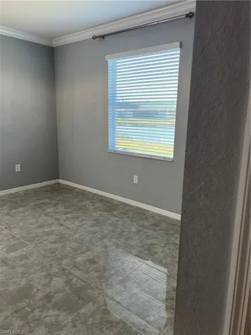 Unfurnished room with baseboards and ornamental molding