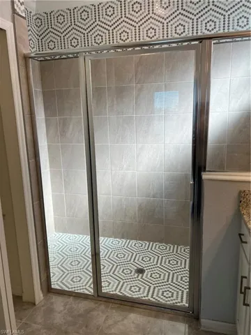 Bathroom featuring vanity and a stall shower