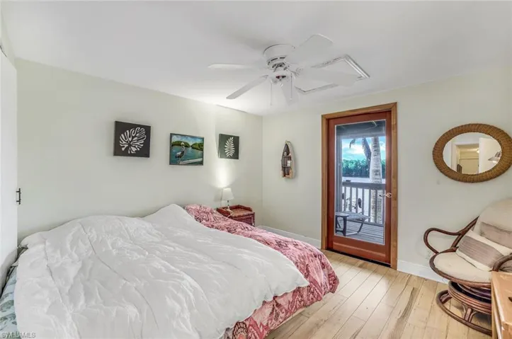 Bedroom with ceiling fan, access to outside, and light wood-type flooring