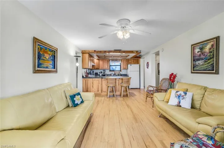 Living room featuring ceiling fan and light hardwood / wood-style flooring