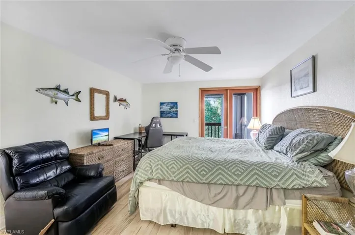 Bedroom with ceiling fan, access to outside, and light hardwood / wood-style floors
