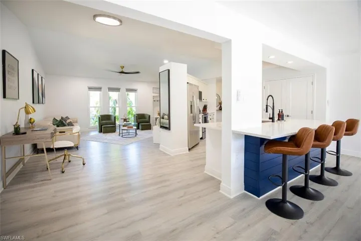 Office desk, with living room view, kitchen and island