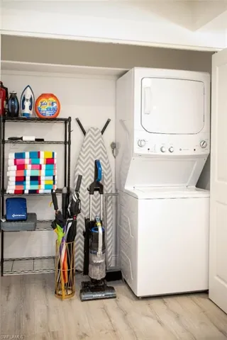 Laundry closet featuring stacked washer / dryer
