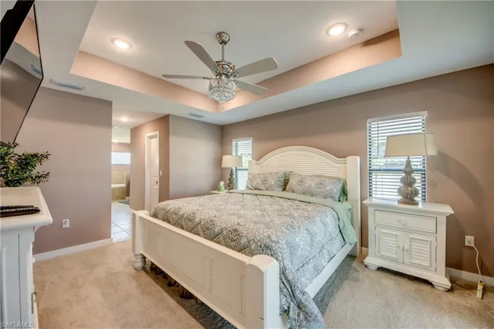 Bedroom featuring light colored carpet and a ceiling fan