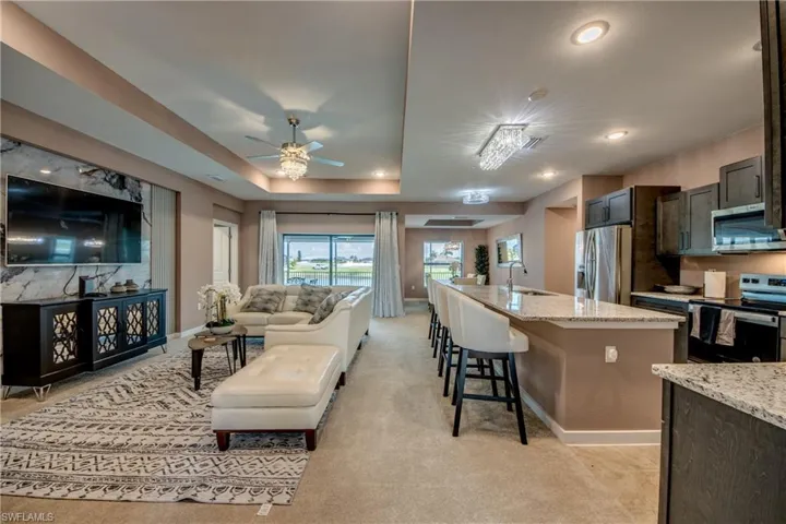 Dining area featuring ceiling fan, a chandelier, and recessed lighting