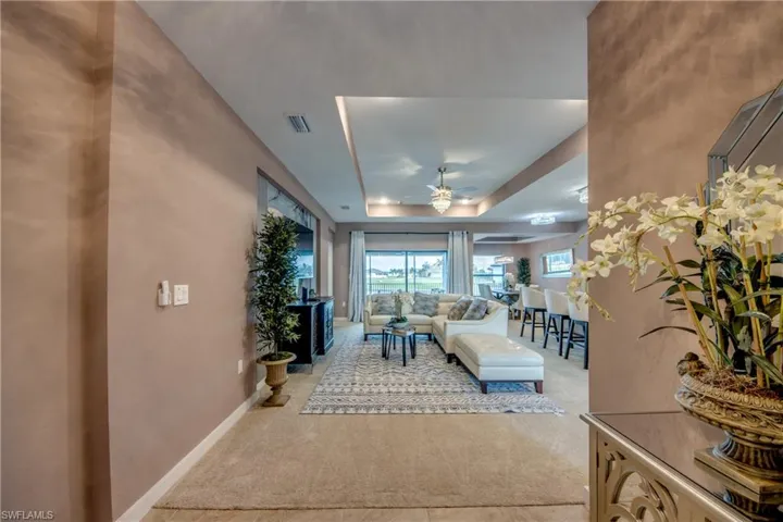 Foyer entrance with light tile patterned floors and a chandelier