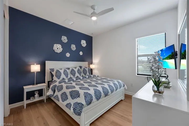 Bedroom featuring ceiling fan and light wood-type flooring