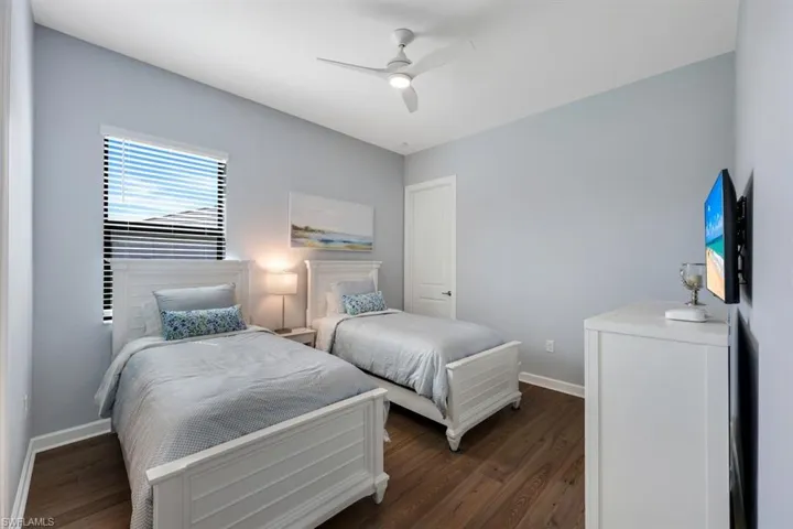 Bedroom featuring dark hardwood / wood-style floors and ceiling fan