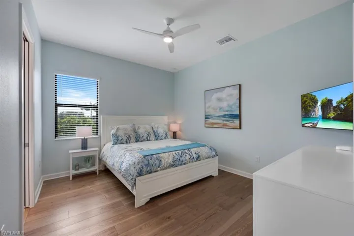 Bedroom featuring hardwood / wood-style floors and ceiling fan